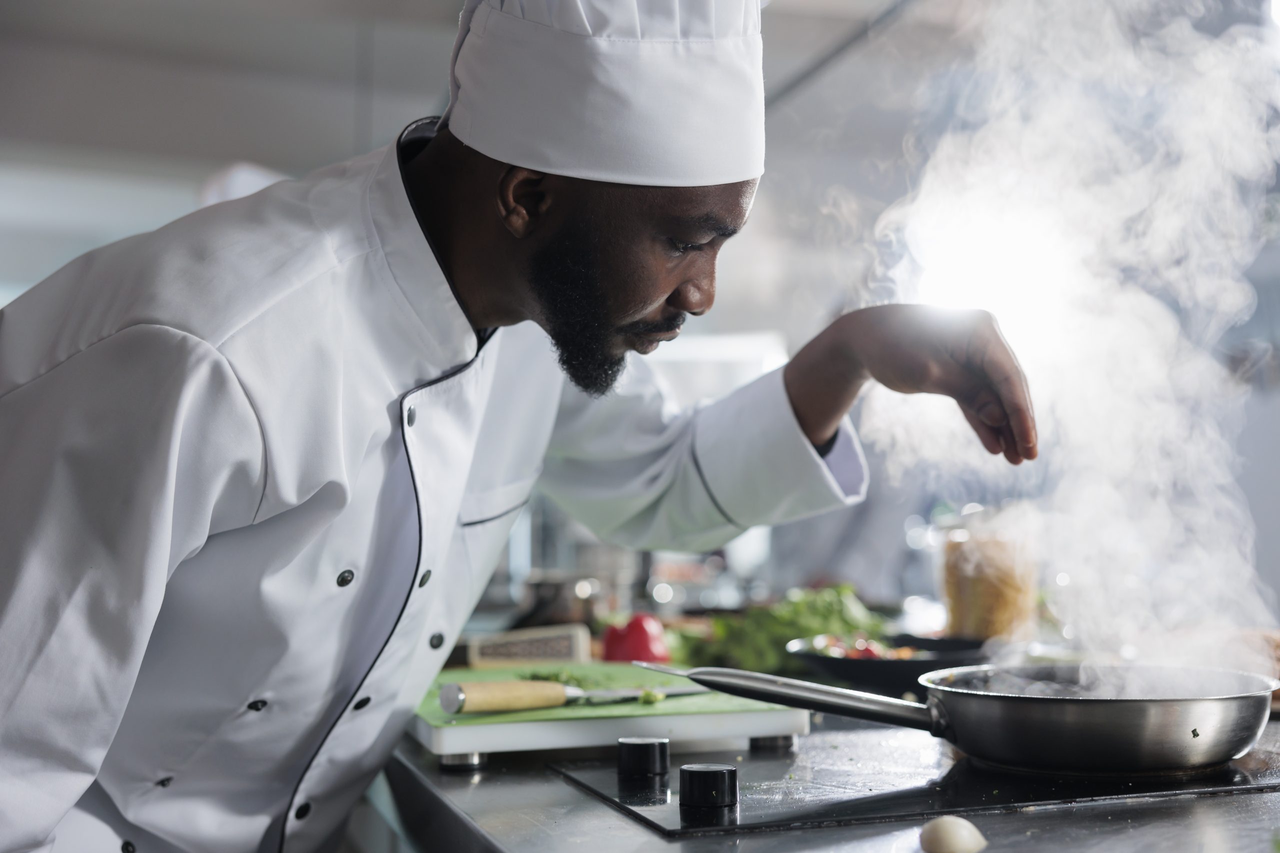 Culinary expert preparing dinner meal service while using fresh vegetables and herbs in restaurant professional kitchen.