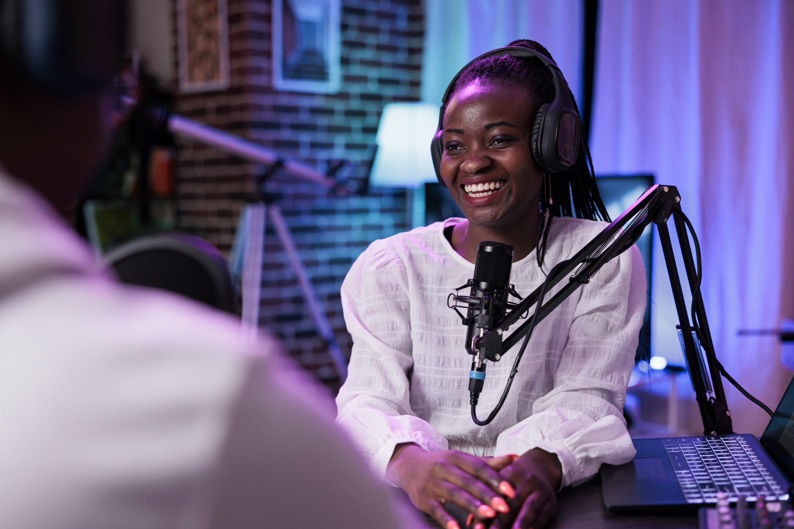 Female influencer interviewing guest on podcast stream