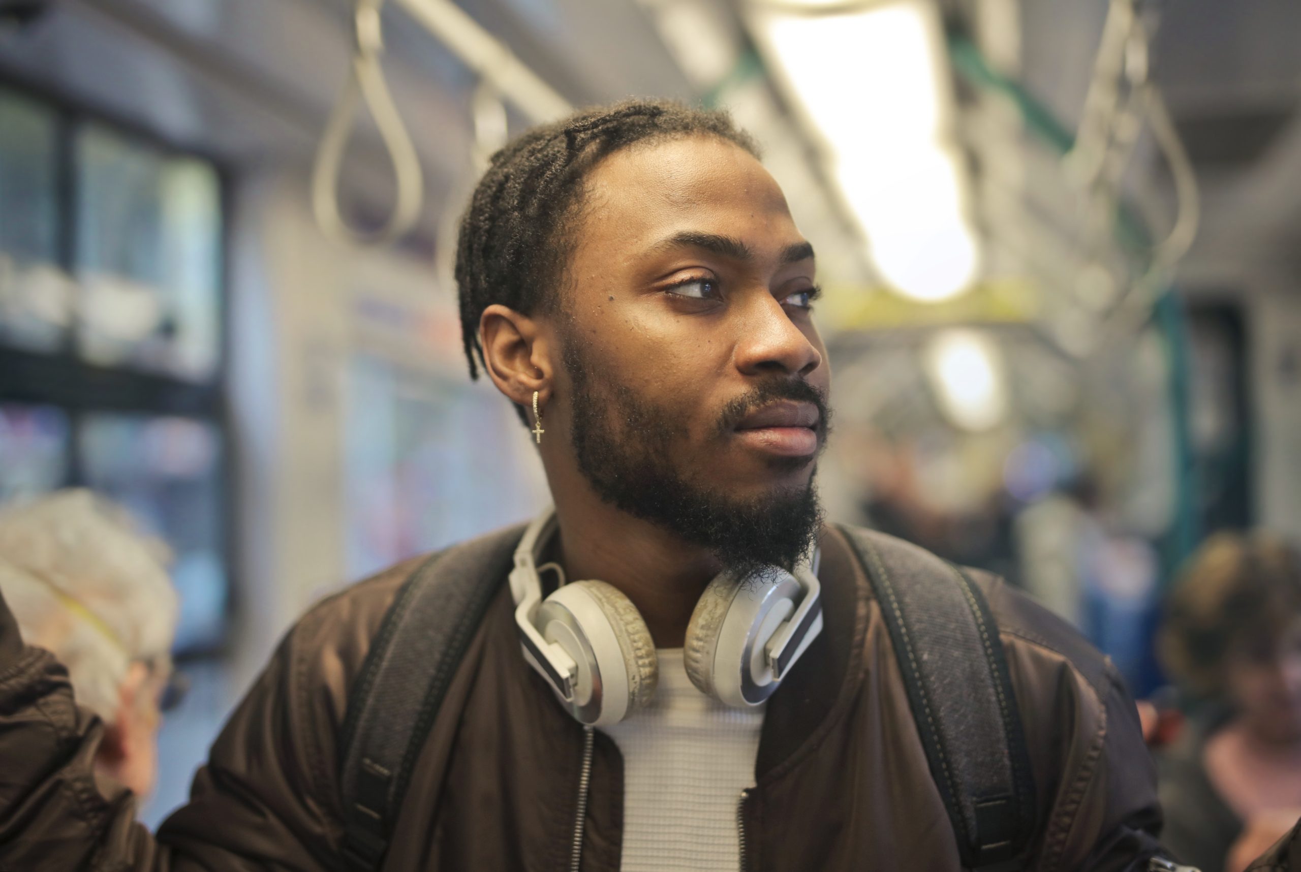 young man with backpack in a tram